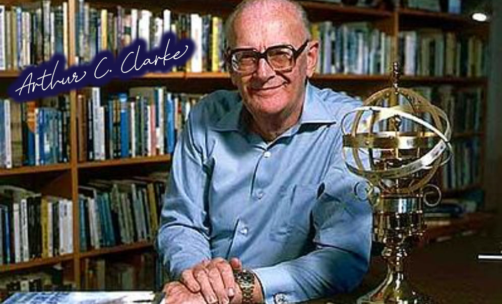 Image of science fiction writer Arthur C Clarke in front of large bookcase with award in front of him.