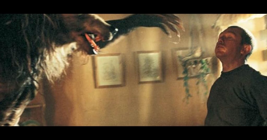 Still from Dog Soldier movie, wolf about to attack man